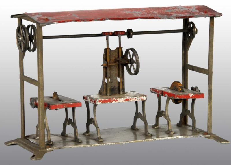 Appraisal: Tin Hand-Painted Workshop Toy Description Includes saw press and knife