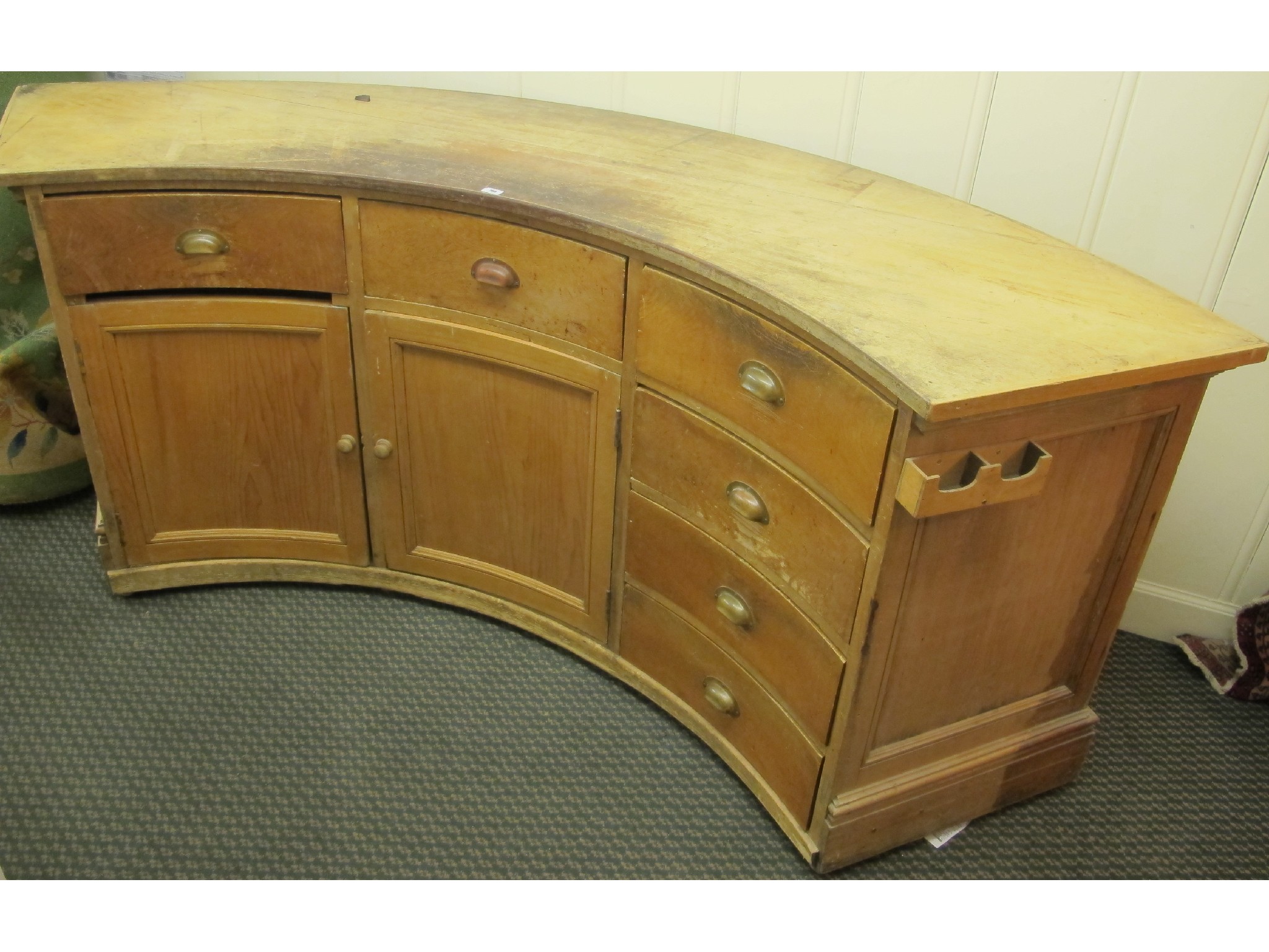 Appraisal: A th Century curved pine counter with six drawers and