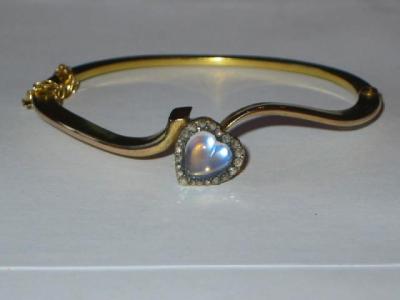 Appraisal: A VICTORIAN MOONSTONE AND DIAMOND BANGLE the yellow gold hinged