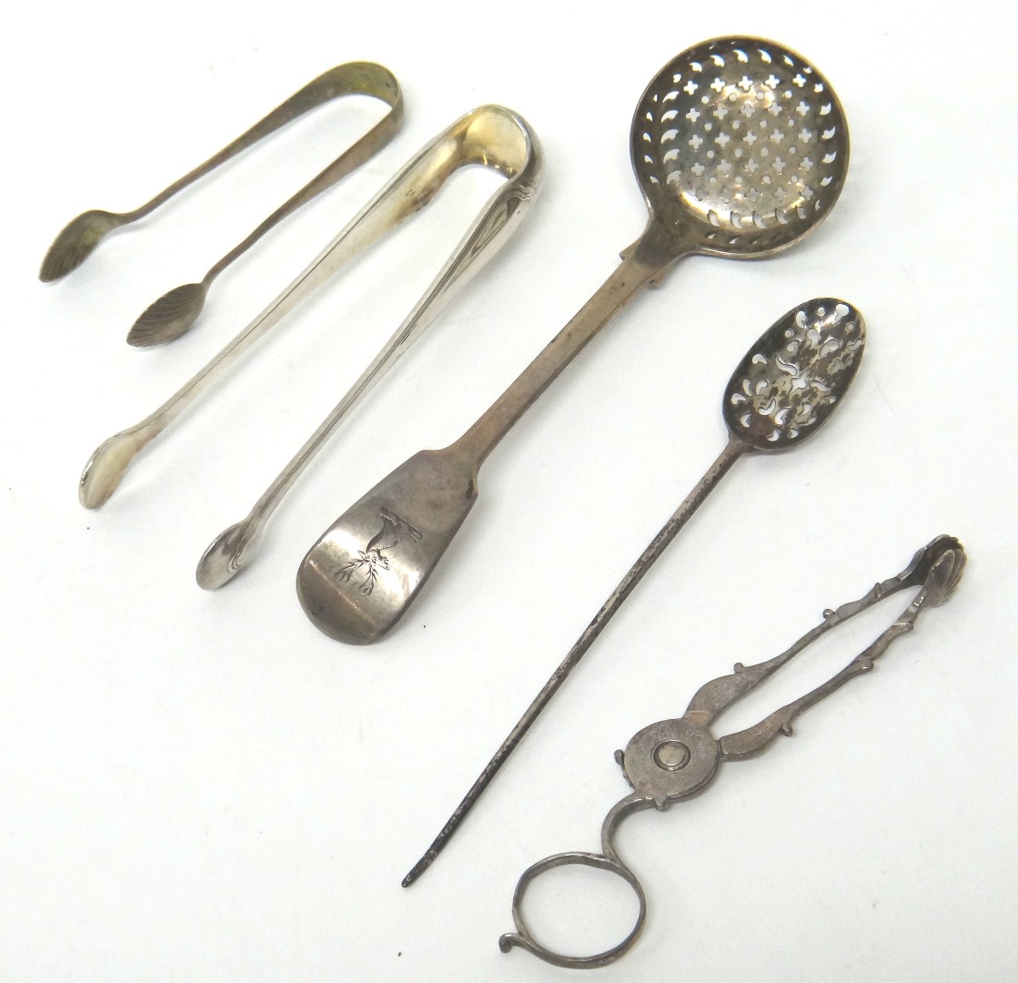 Appraisal: Silver comprising a fiddle pattern sugar sifting spoon London a