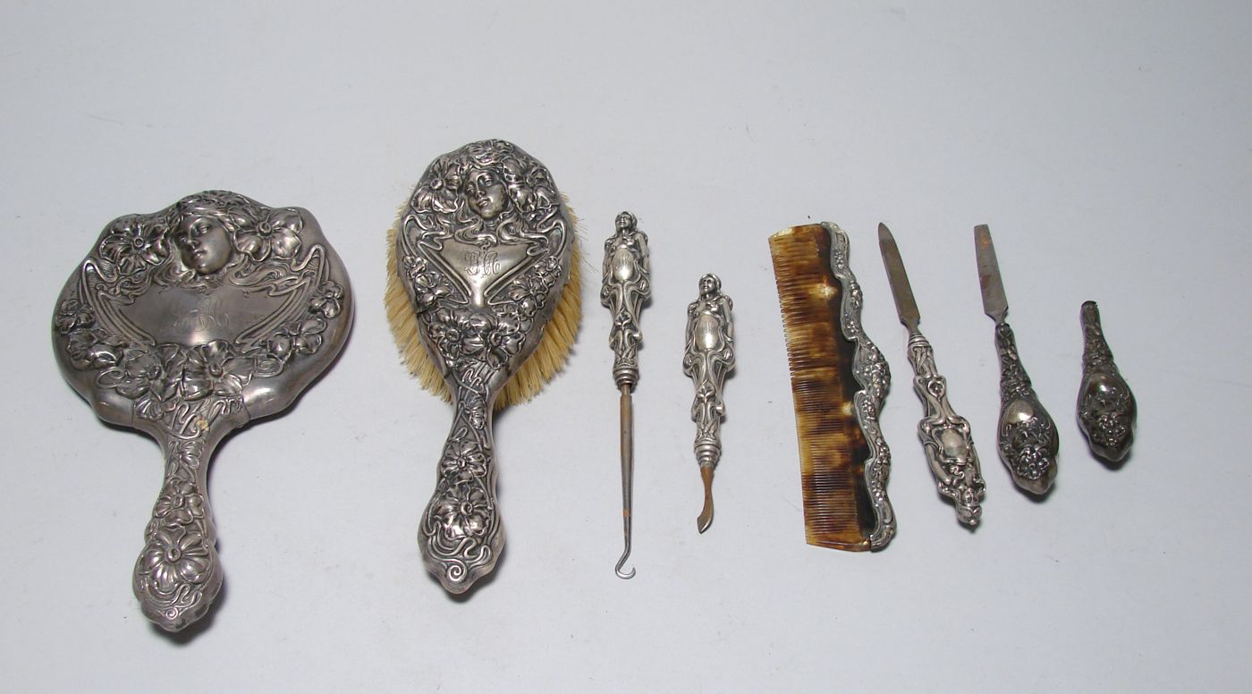 Appraisal: ART NOUVEAU STERLING SILVER DRESSER SET With chased decoration of