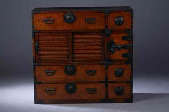 Appraisal: JAPANESE WOOD TANSU Meiji period The rectangular top above seven