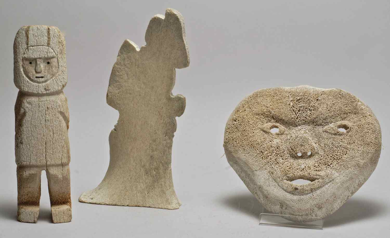 Appraisal: THREE ESKIMO WHALEBONE ITEMS th CenturyTwo figural carvings heights and