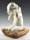 Appraisal: MIXED MARBLE SCULPTURE - Nude Toddler Kneeling on Pillow with