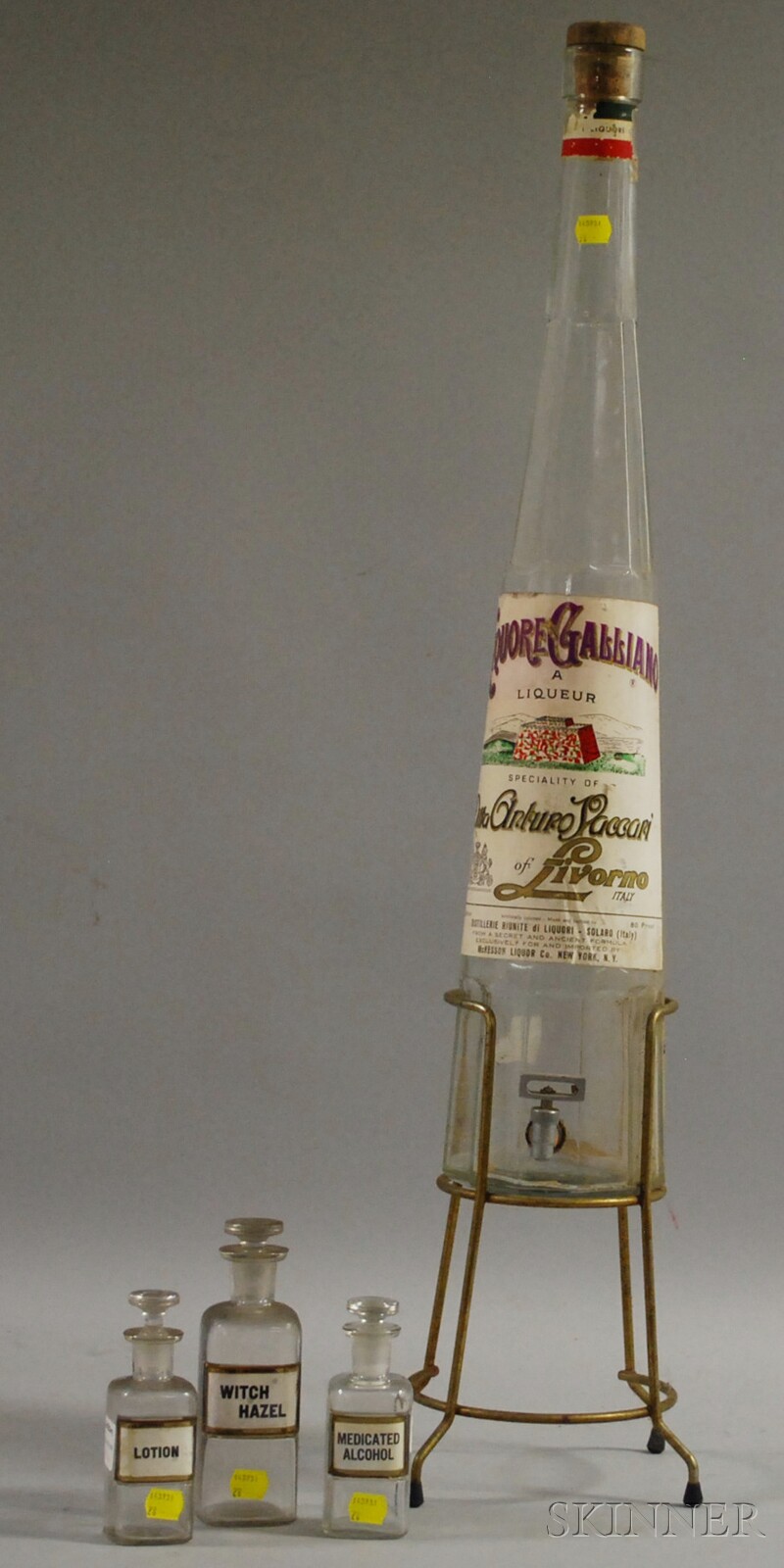 Appraisal: Colorless Glass Bottle-form Liquor Dispenser with Spigot and Metal Stand