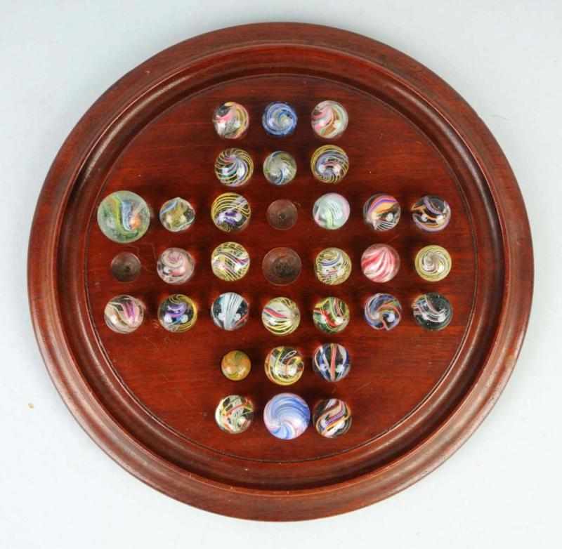 Appraisal: Lot of Handmade Marbles on Original Board Description Includes mostly