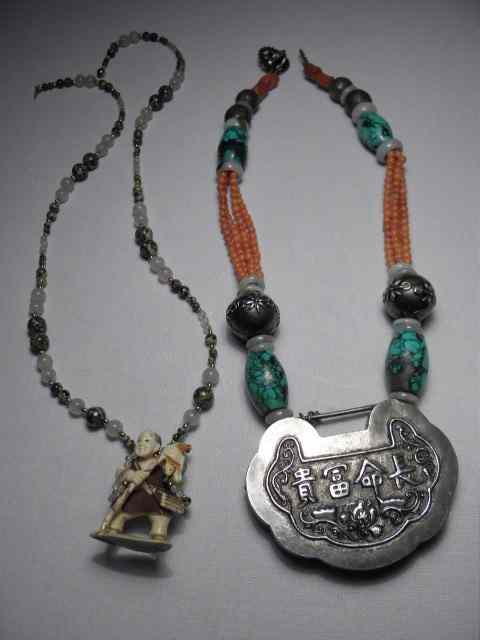 Appraisal: Two Chinese necklaces or amulets The first is beaded with