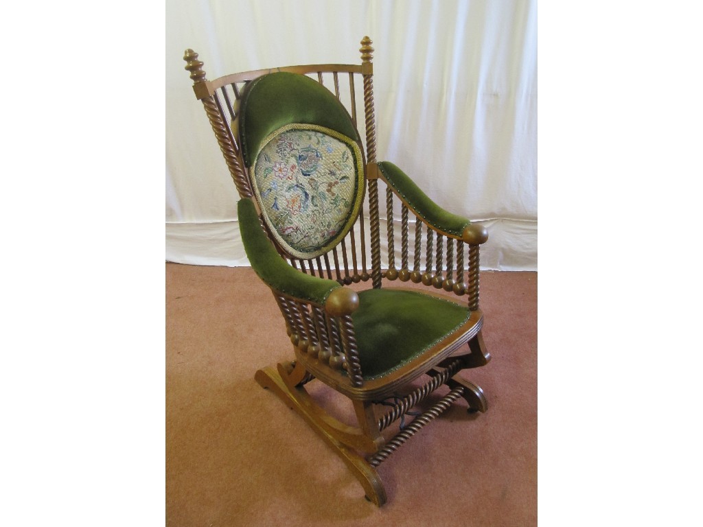 Appraisal: A Victorian American mahogany spring rocker armchair decorated with spiral