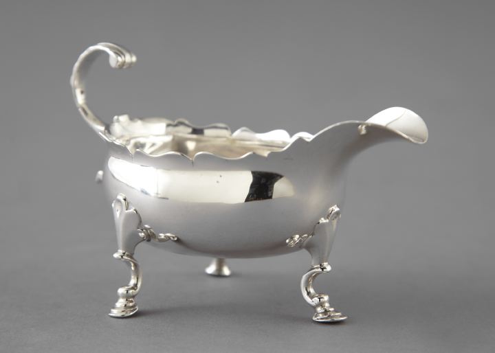 Appraisal: George II Sterling Silver Tripodal Cream Pitcher with scalloped rim