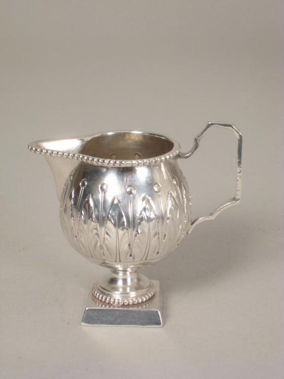 Appraisal: A Continental white metal Cream Jug with leafage frieze and