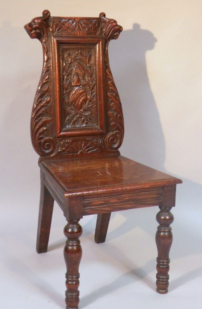 Appraisal: A late thC oak hall chair the serpentine back headed