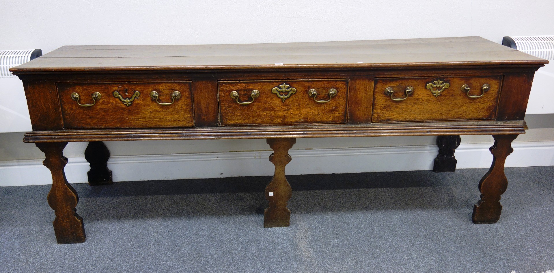 Appraisal: An th century oak dresser base with three frieze drawers