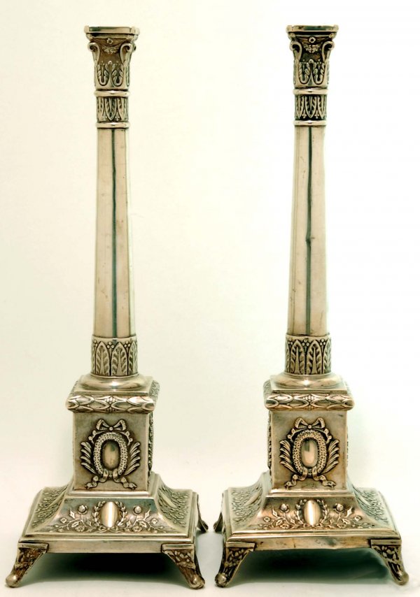 Appraisal: A pair of Polish silver candlesticks Acanthus and swag sconces