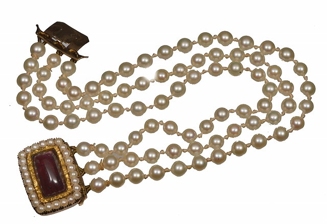 Appraisal: A TRIPLE ROW PEARL BRACELET attached to a garnet and