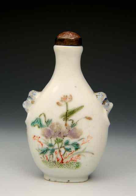 Appraisal: A CHINESE WHITE PORCELAIN SNUFF BOTTLE with lion mask handles