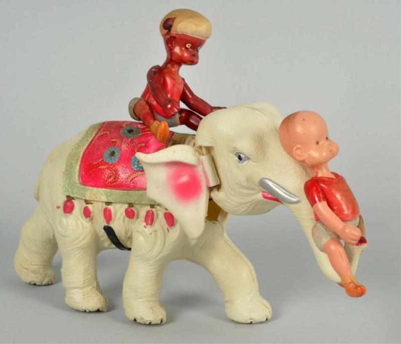 Appraisal: Celluloid Henry on Elephant Wind-Up Toy Japanese Pre-war White elephant