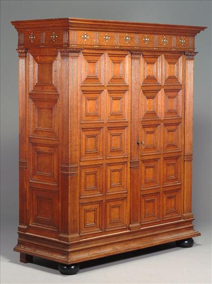 Appraisal: A Continental oak and brass studded press cupboard th century