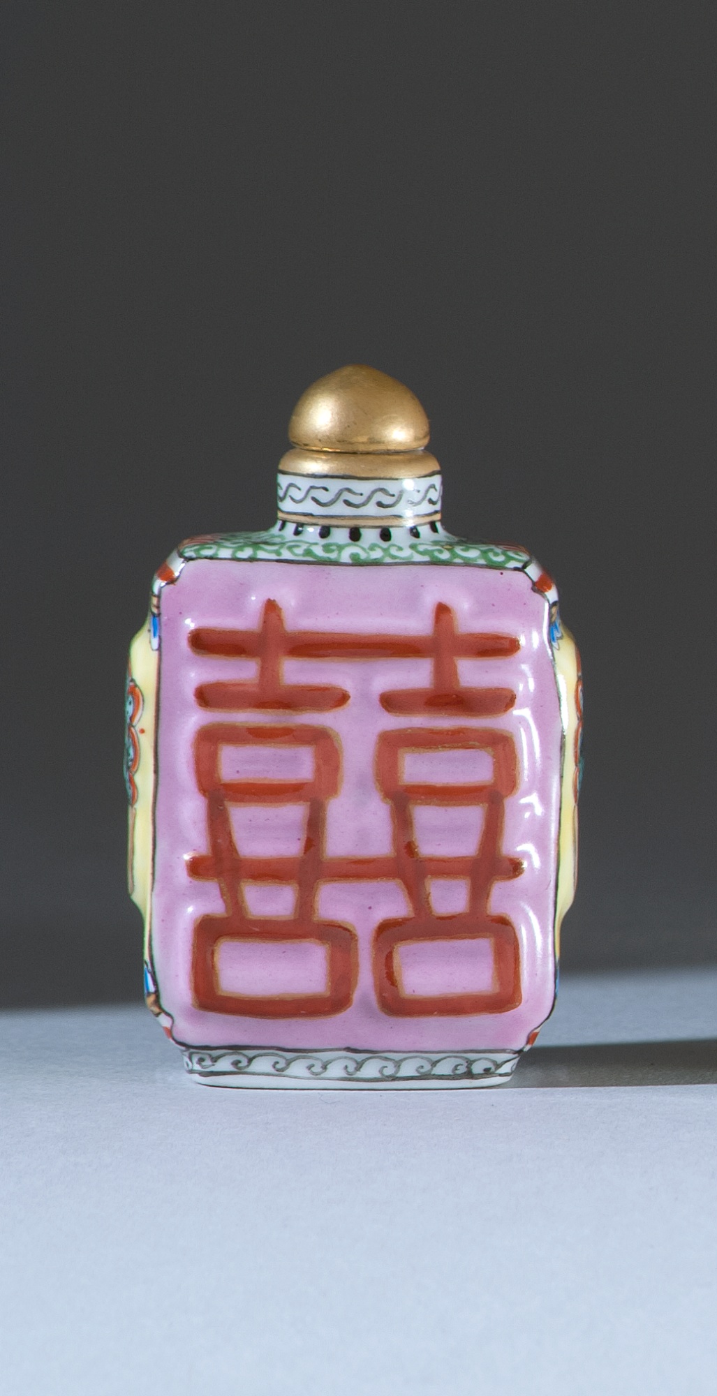 Appraisal: POLYCHROME PORCELAIN SNUFF BOTTLE In rectangular form with mask and