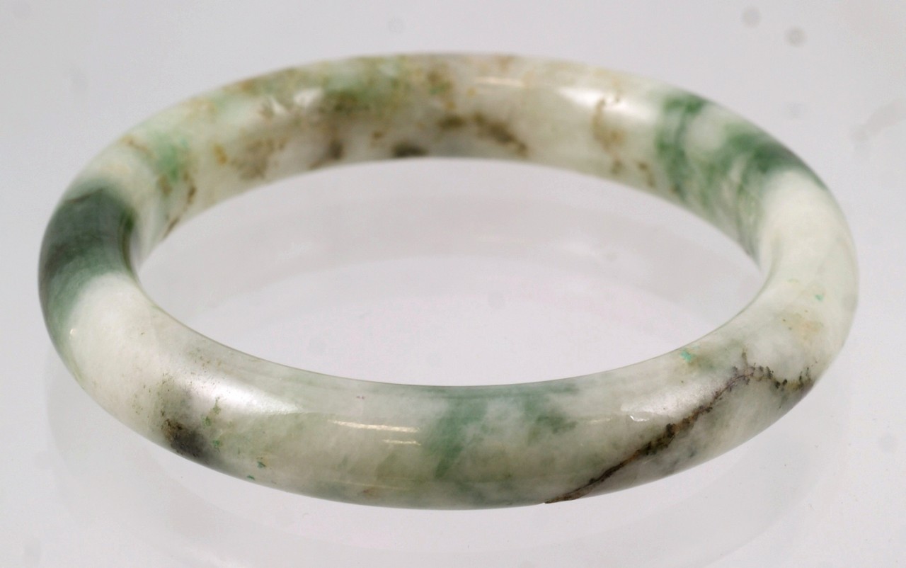 Appraisal: Mottled light and dark green jade bangle ID OD