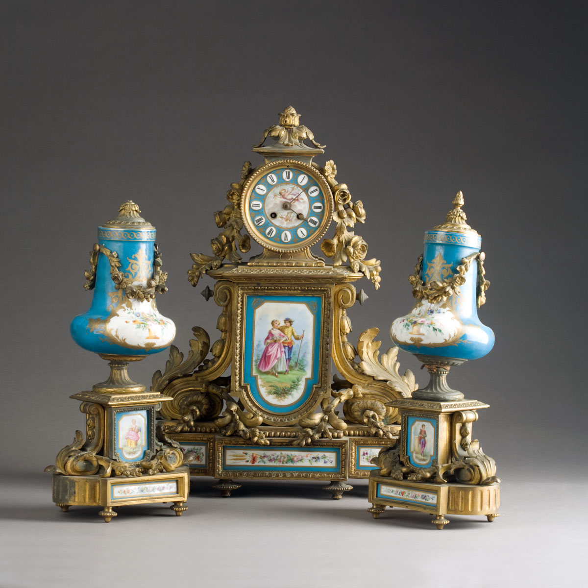 Appraisal: NAPOLEON III GILT-BRONZE AND PORCELAIN-MOUNTED THREE-PIECE CLOCK GARNITURE MID-LATE NINETEENTH