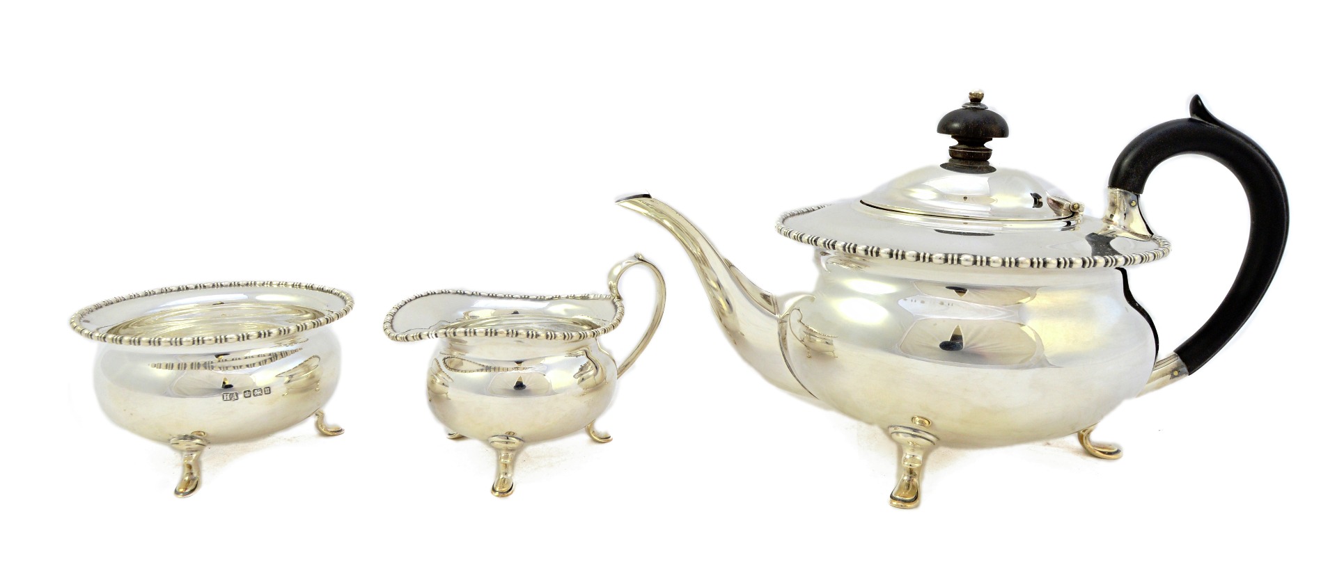 Appraisal: A silver three piece tea set comprising a teapot Sheffield