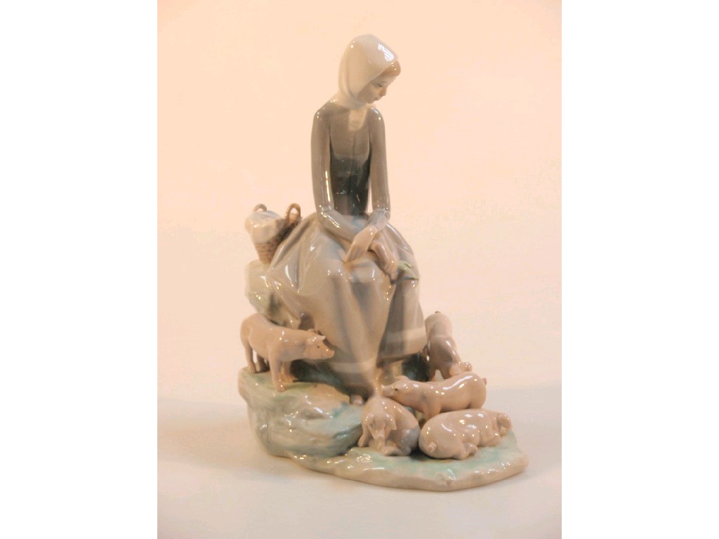 Appraisal: A Lladro figure group of a young girl with piglets