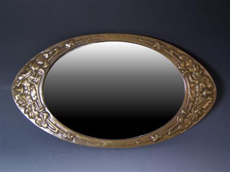 Appraisal: ARTS AND CRAFTS OVAL WALL MIRROR CIRCA brass the bevelled