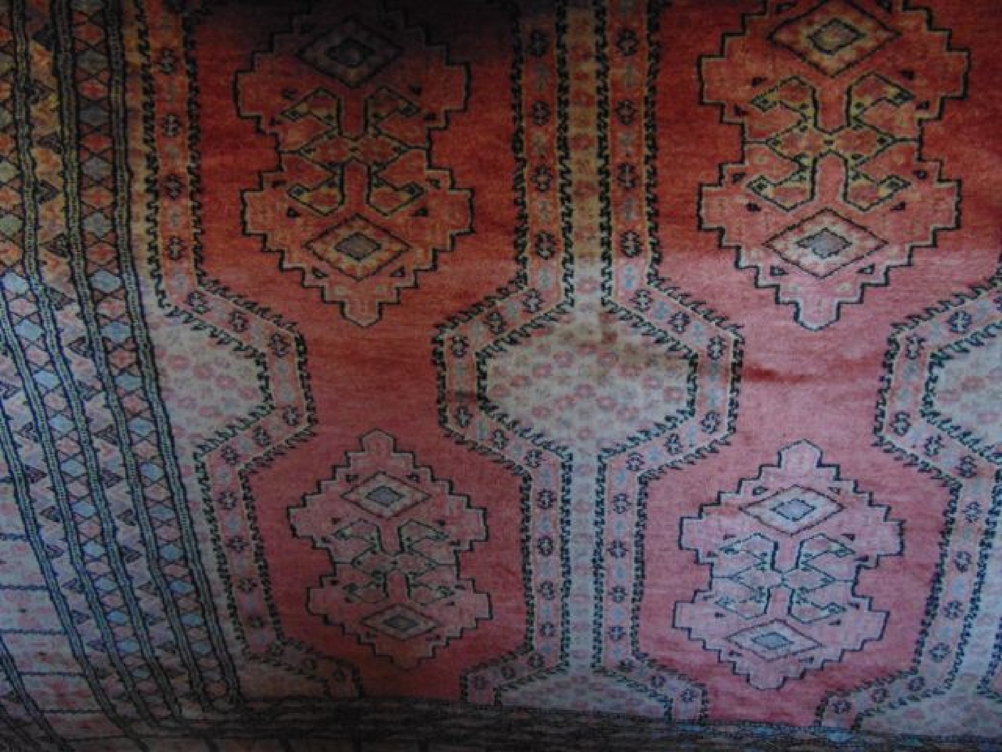 Appraisal: An Afghan style wool rug with multi medallion centre upon