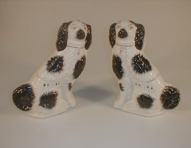 Appraisal: A pair of late thC Staffordshire pottery seated spaniels with