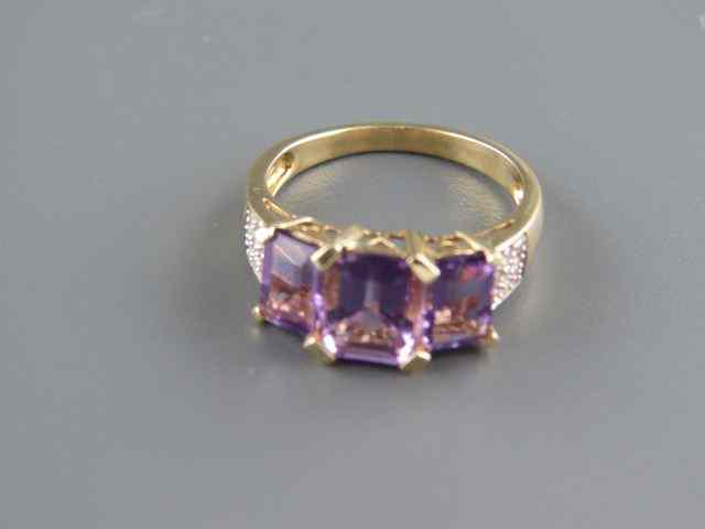 Appraisal: Amethyst Ring a trio of emerald cut gems totaling carats