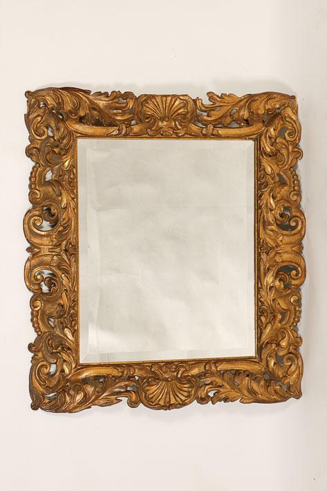 Appraisal: A BAROQUE STYLE CARVED GILTWOOD WALL MIRROR the later rectangular