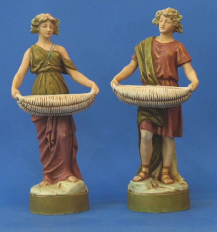 Appraisal: A PAIR OF ROYAL DUX FIGURES OF ROMAN SLAVES CARRYING