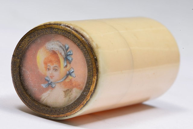 Appraisal: AN IVORY CYLINDRICAL NEEDLECASE with inset painted miniature top