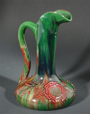 Appraisal: A Sunflower Pottery ewer designed by Sir Edmund Elton slip