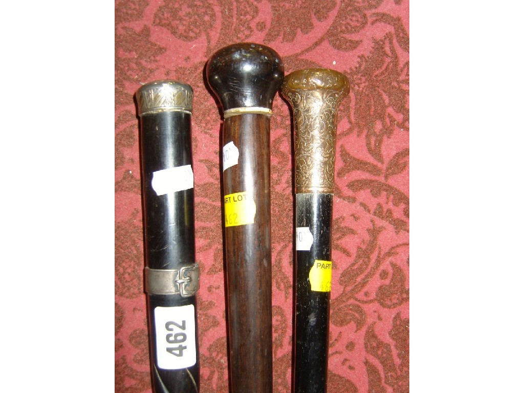 Appraisal: A collection of three walking canes including example with silver