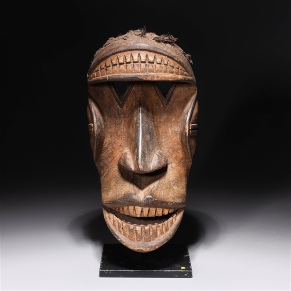 Appraisal: Carved wooden African mask with custom stand overall good condition