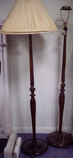 Appraisal: A pair of stained beech standard lamps on a turned