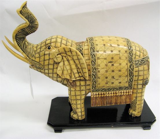 Appraisal: BONE CARVED FIGURE OF AN ELEPHANT with upraised trunk sharp