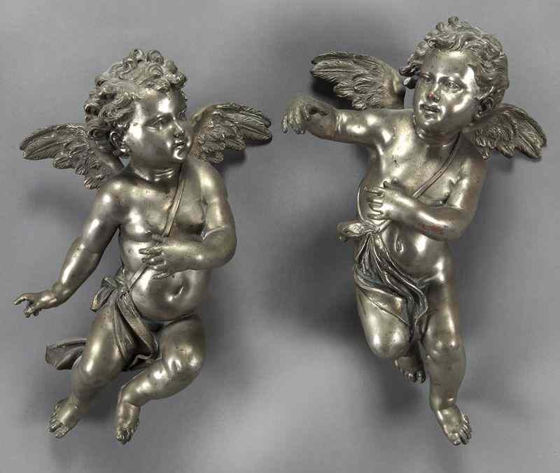 Appraisal: Pr German silvered bronze cherub wall mounts each draped figure