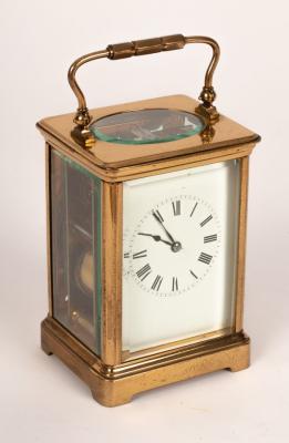 Appraisal: A gilt cased eight-day carriage clock with white enamel dial