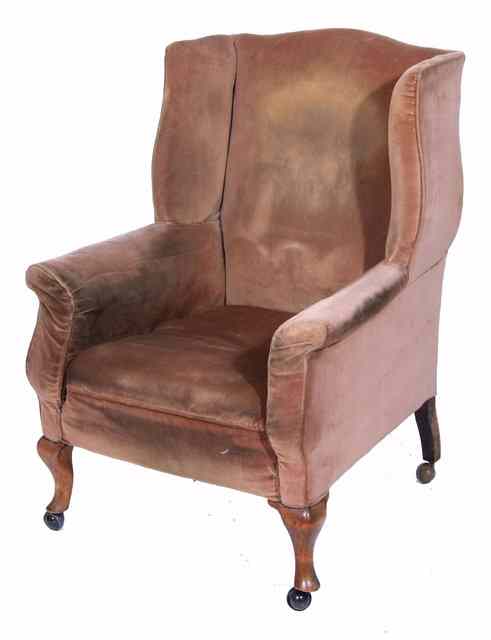 Appraisal: A WING BACK ARMCHAIR standing on short cabriole front legs