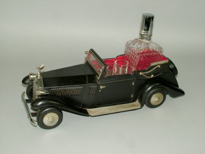 Appraisal: A Schnapps tin plate decanter trolley in the form of