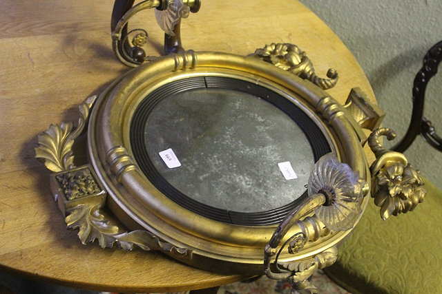 Appraisal: AN EARLY VICTORIAN GIRANDOLE CONVEX MIRROR with leaf and fruit