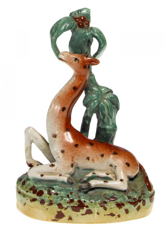 Appraisal: A STAFFORDSHIRE MODEL OF A GIRAFFE AT LODGE before a