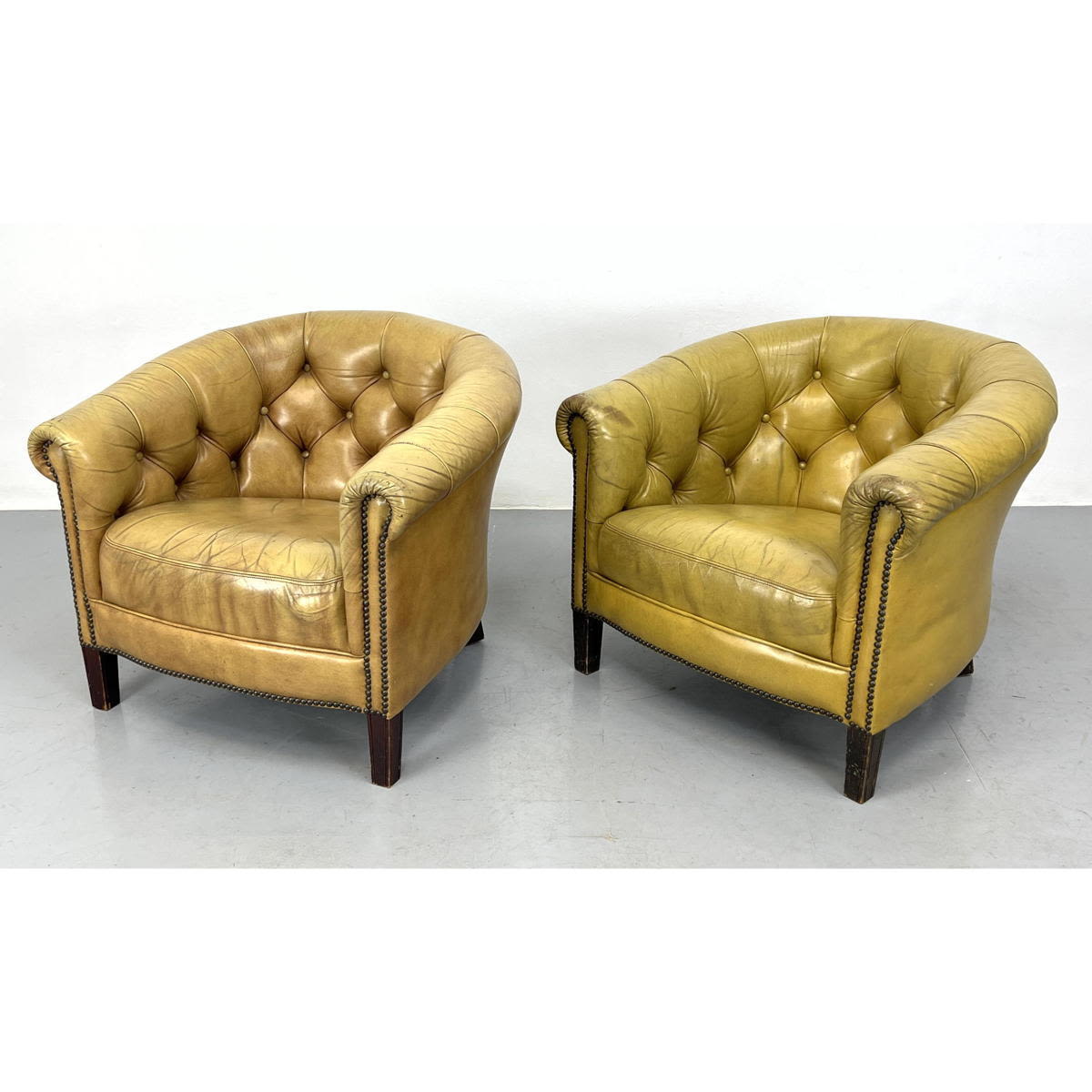 Appraisal: Pr Golden Tan Leather Chesterfield style Lounge Chairs Barrel Back