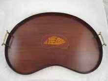 Appraisal: An Edwardian mahogany kidney shaped tray with central satinwood shell