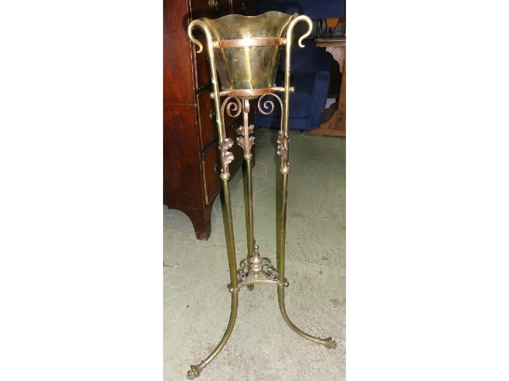 Appraisal: An Arts Crafts style brass jardiniere mounted on swept tripod