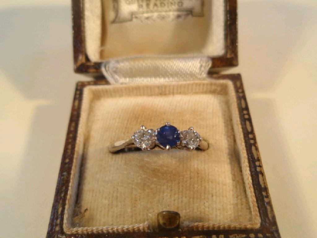 Appraisal: A three stone set ring a small central round sapphire