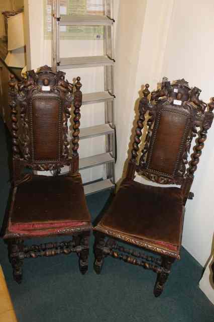 Appraisal: A PAIR OF VICTORIAN CARVED OAK HALL CHAIRS with upholstered