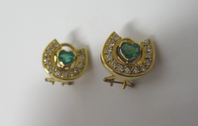 Appraisal: A pair of gold emerald and diamond set earclips each